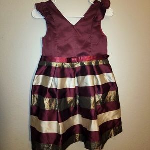 2 girls maroon and gold dresses.